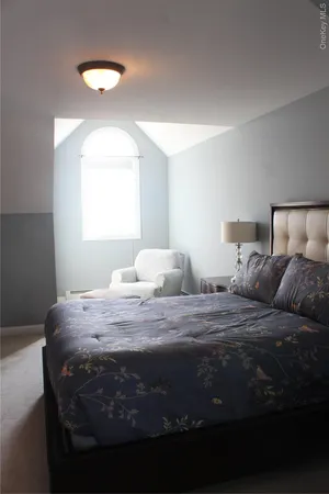 a bedroom with a bed and a night stand