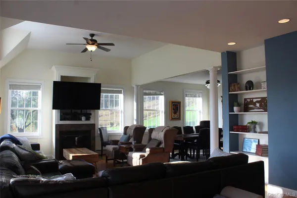 a living room with furniture a fireplace and a flat screen tv