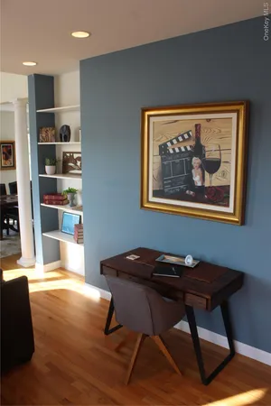 a view of a workspace with furniture and wooden floor