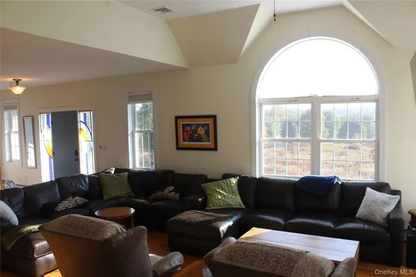 a living room with furniture and a large window