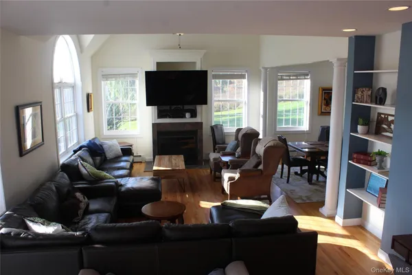 a living room with furniture flat screen tv and a fireplace