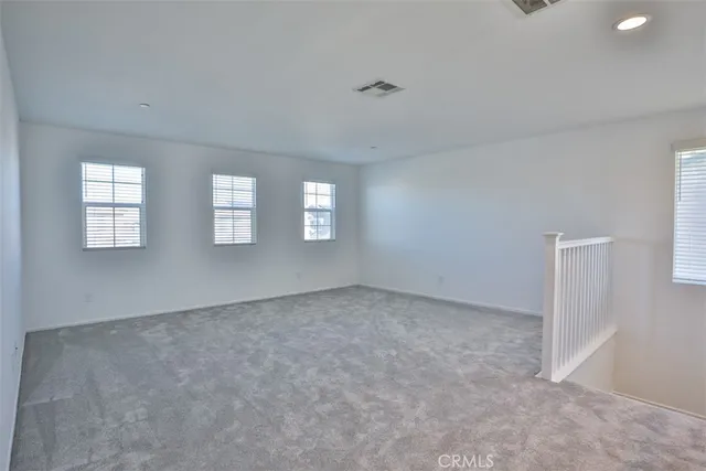 a view of an empty room with windows