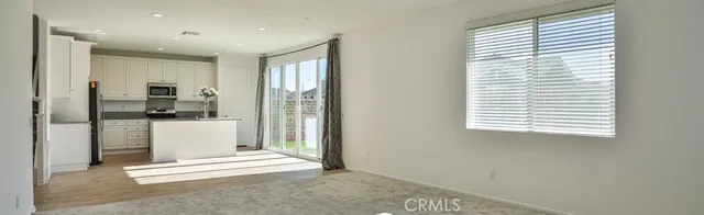 a view of kitchen with stainless steel appliances refrigerator oven and cabinets