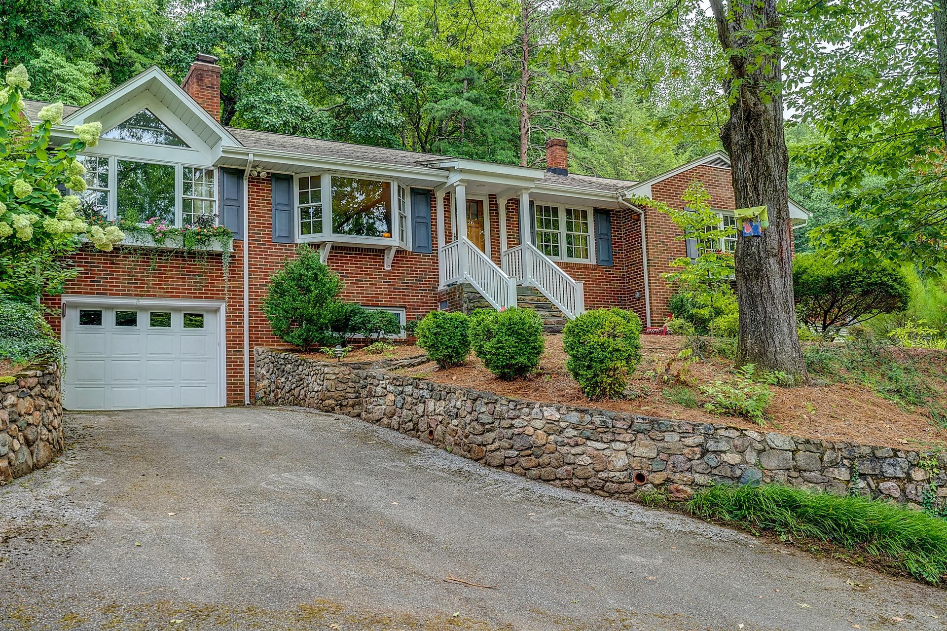 3126 Stoneridge Road Southwest Roanoke, VA 24014 - Photo 2 of 48 a front view of a house with a garden