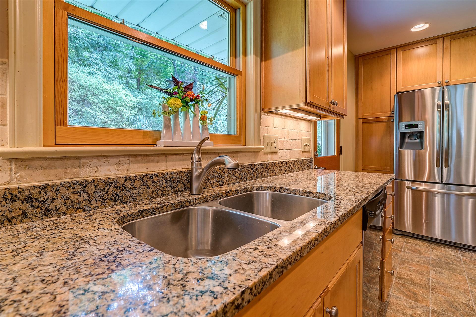 3126 Stoneridge Road Southwest Roanoke, VA 24014 - Photo 18 of 48 a kitchen with a sink a counter top space cabinets and a large window