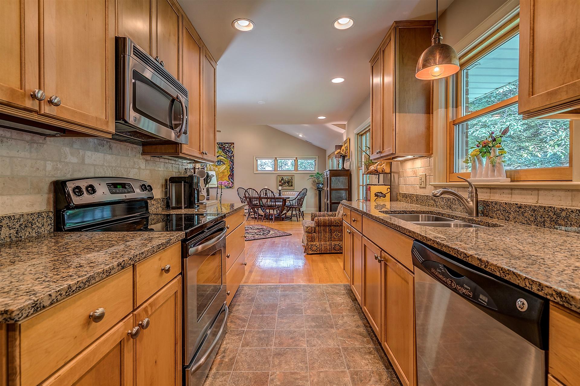 3126 Stoneridge Road Southwest Roanoke, VA 24014 - Photo 20 of 48 a kitchen with stainless steel appliances granite countertop a stove a sink and a microwave