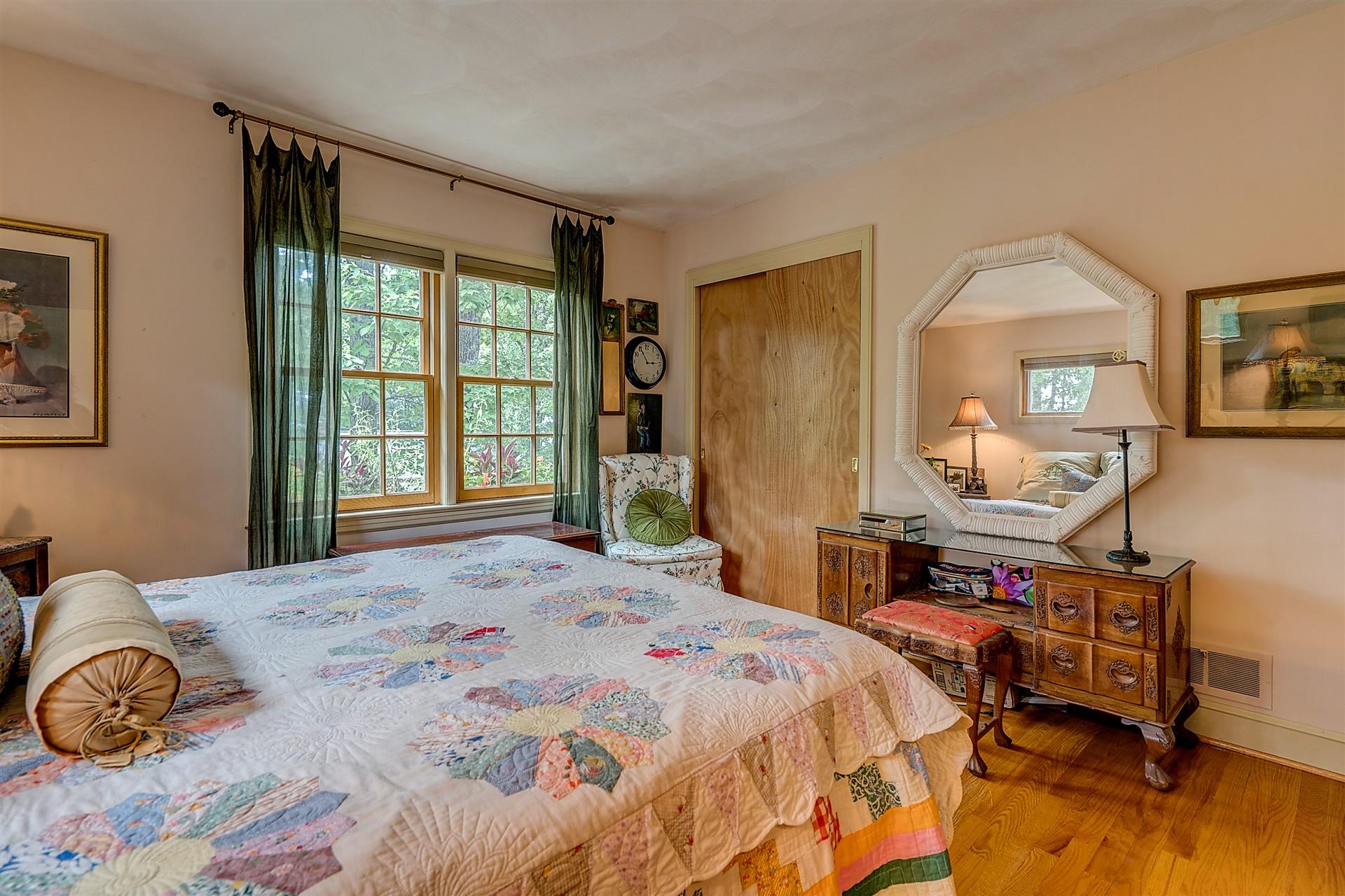 3126 Stoneridge Road Southwest Roanoke, VA 24014 - Photo 27 of 48 a bedroom with a bed a table and a large mirror next to a window