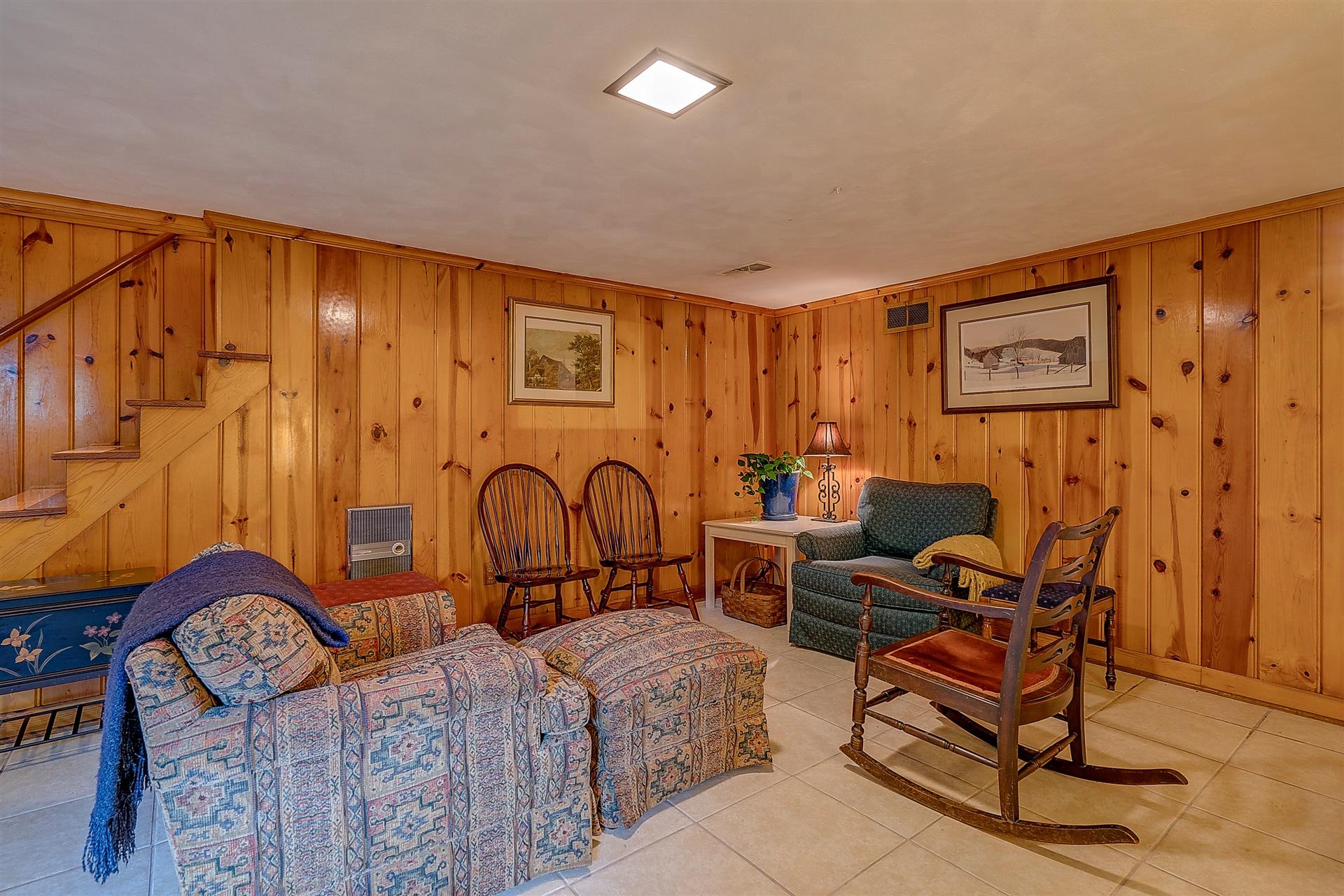 3126 Stoneridge Road Southwest Roanoke, VA 24014 - Photo 35 of 48 a living room with furniture a rug and a wall painting