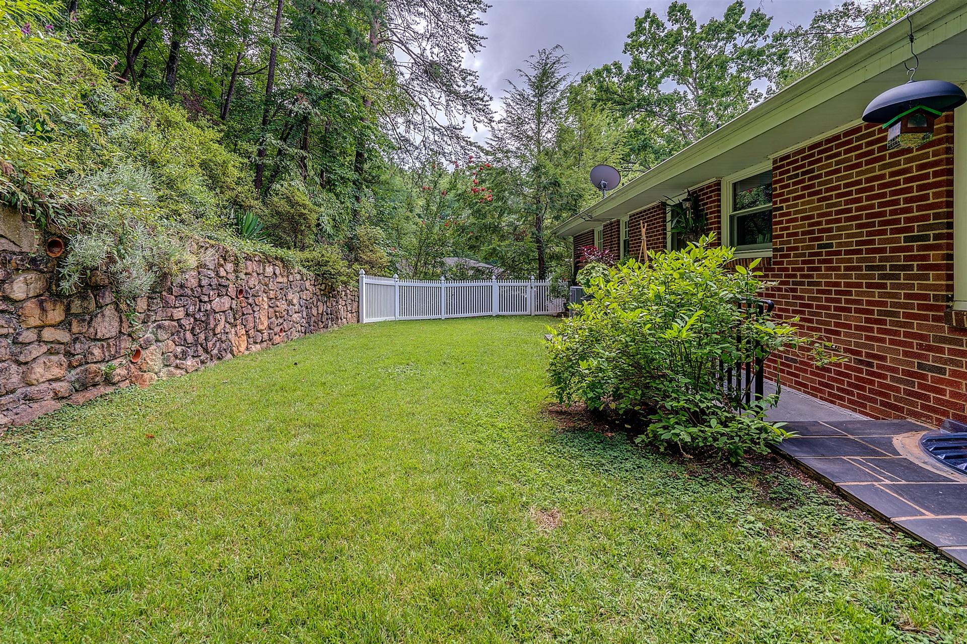 3126 Stoneridge Road Southwest Roanoke, VA 24014 - Photo 44 of 48 a view of a backyard with plants and large trees