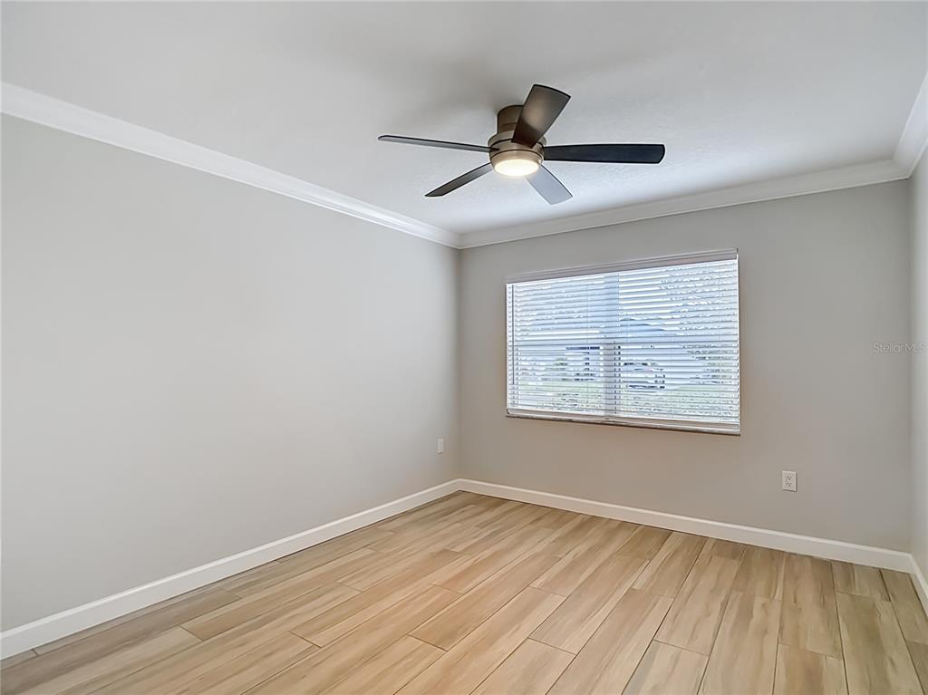 4536 Mitcher Road New Port Richey, FL 34652 - Photo 22 of 46 a view of an empty room with wooden floor and a window