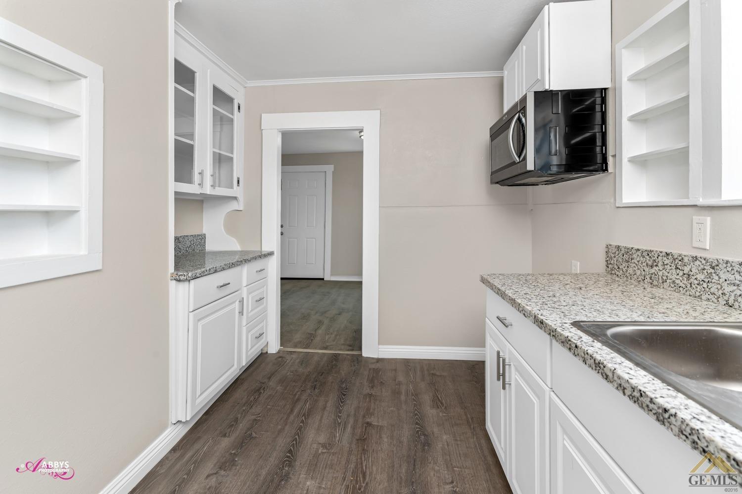 Undisclosed Address Taft, CA 93268 - Photo 12 of 30 a kitchen with stainless steel appliances granite countertop a sink stove and microwave