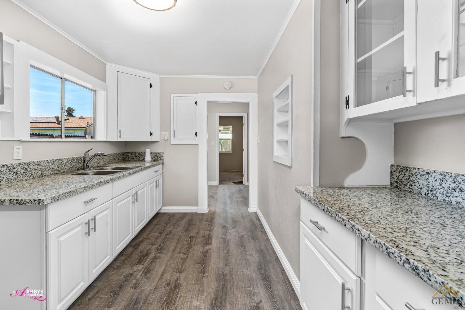 Undisclosed Address Taft, CA 93268 - Photo 17 of 30 a kitchen with granite countertop a sink and cabinets