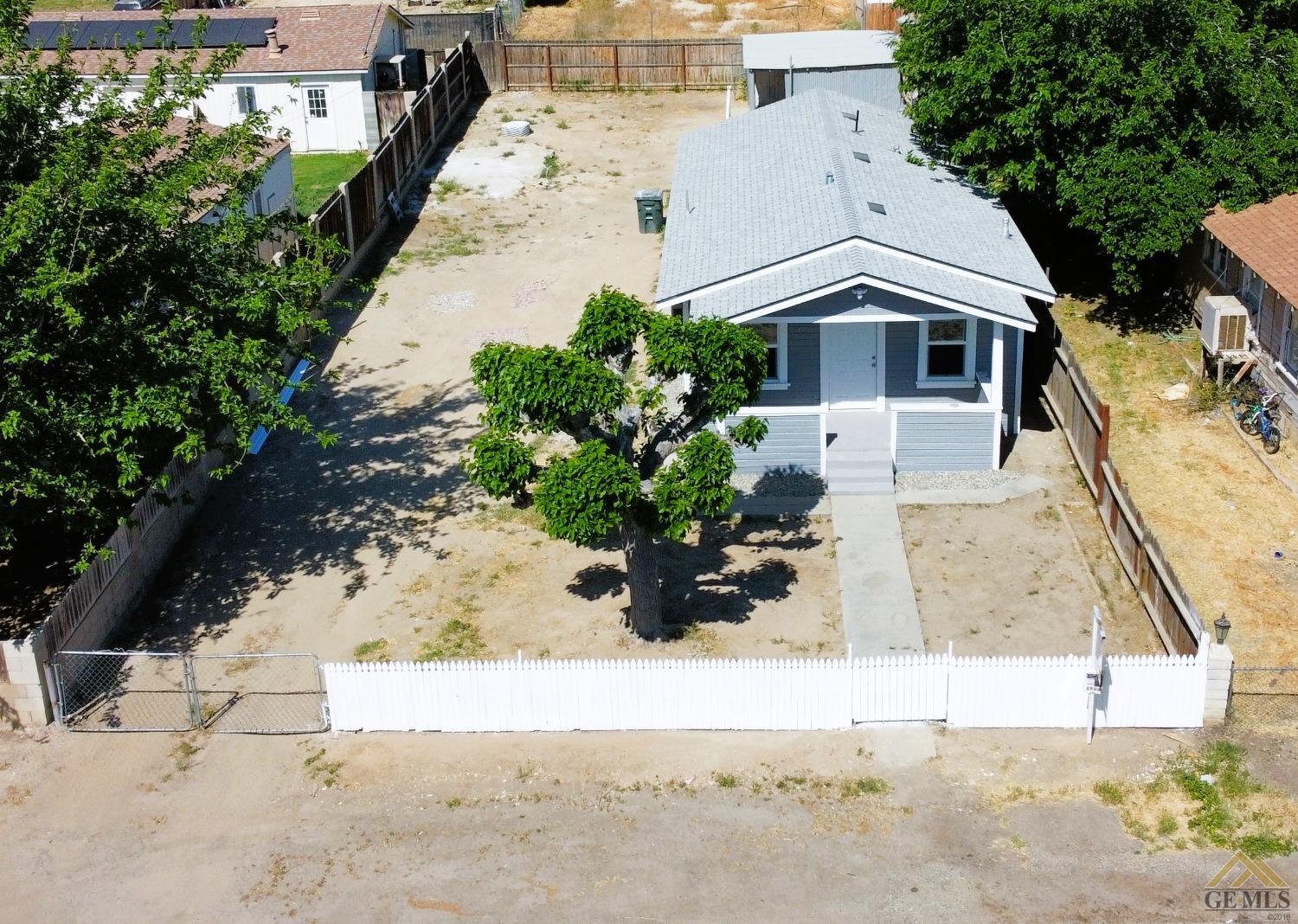 Undisclosed Address Taft, CA 93268 - Photo 3 of 30 a front view of a house with a yard