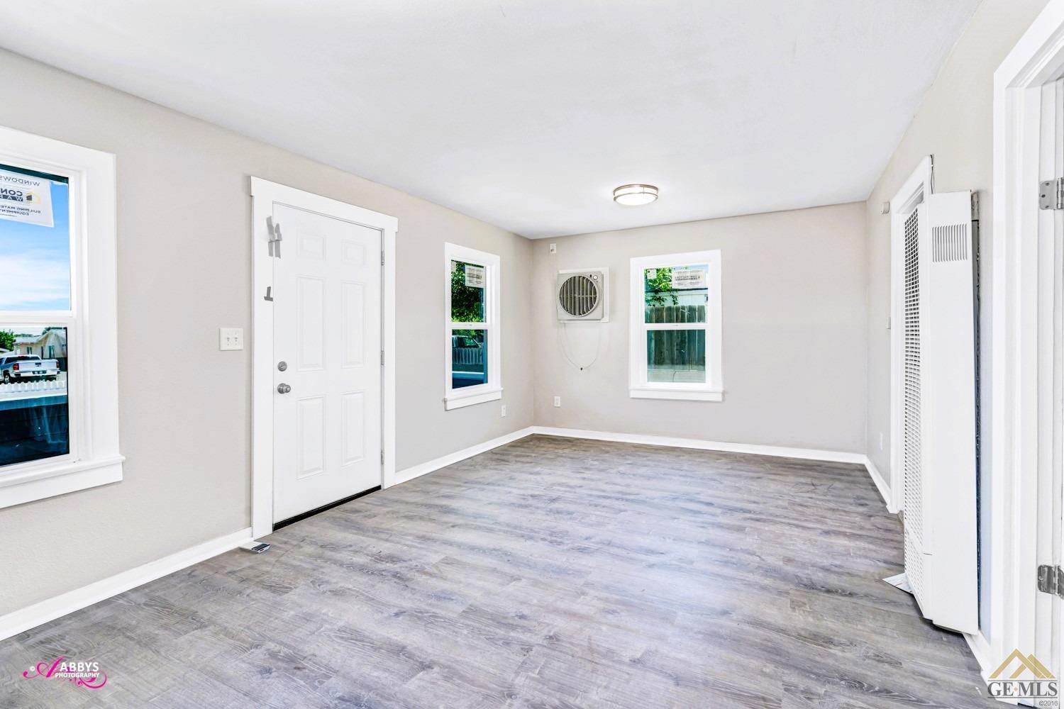 Undisclosed Address Taft, CA 93268 - Photo 7 of 30 an empty room with wooden floor and windows