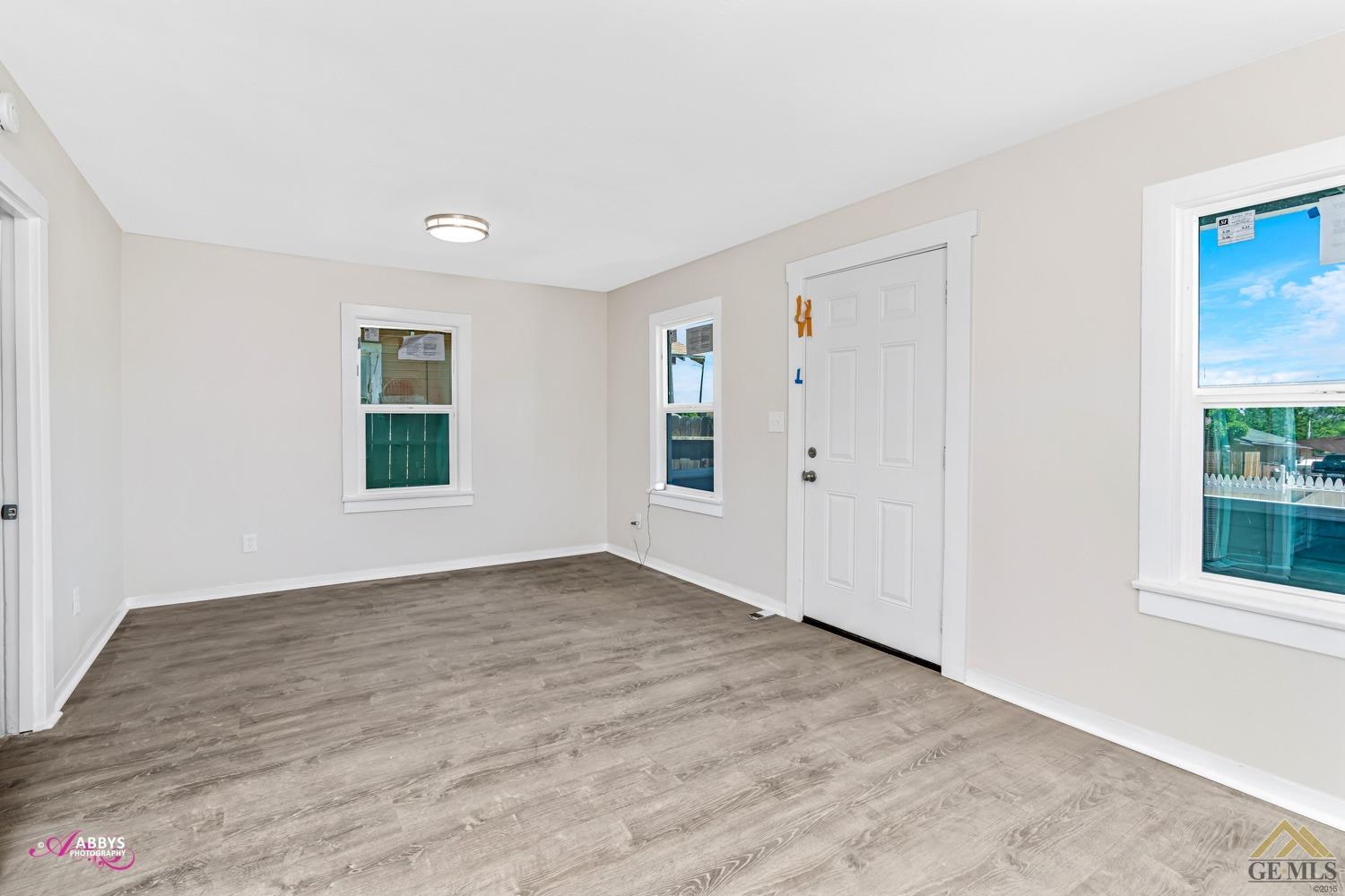 Undisclosed Address Taft, CA 93268 - Photo 8 of 30 an empty room with wooden floor and windows