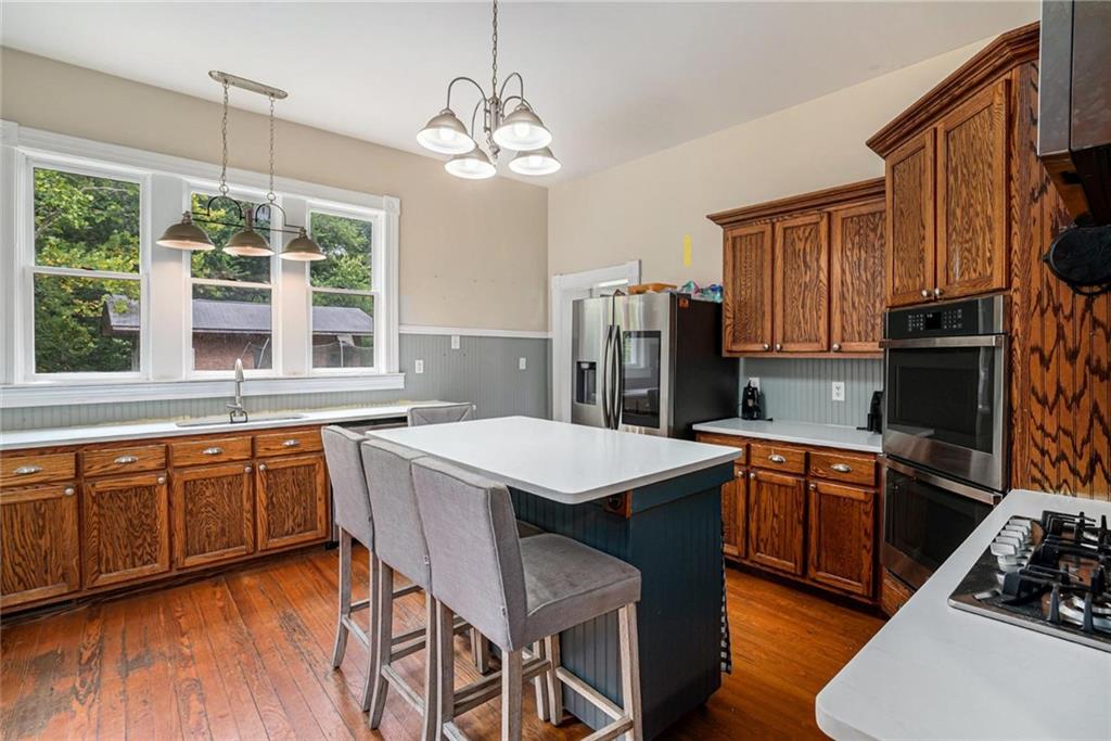 35 Old Mill Road Cedartown, GA 30125 - Photo 13 of 30 a kitchen with stainless steel appliances granite countertop wooden floors a stove a sink a refrigerator and island