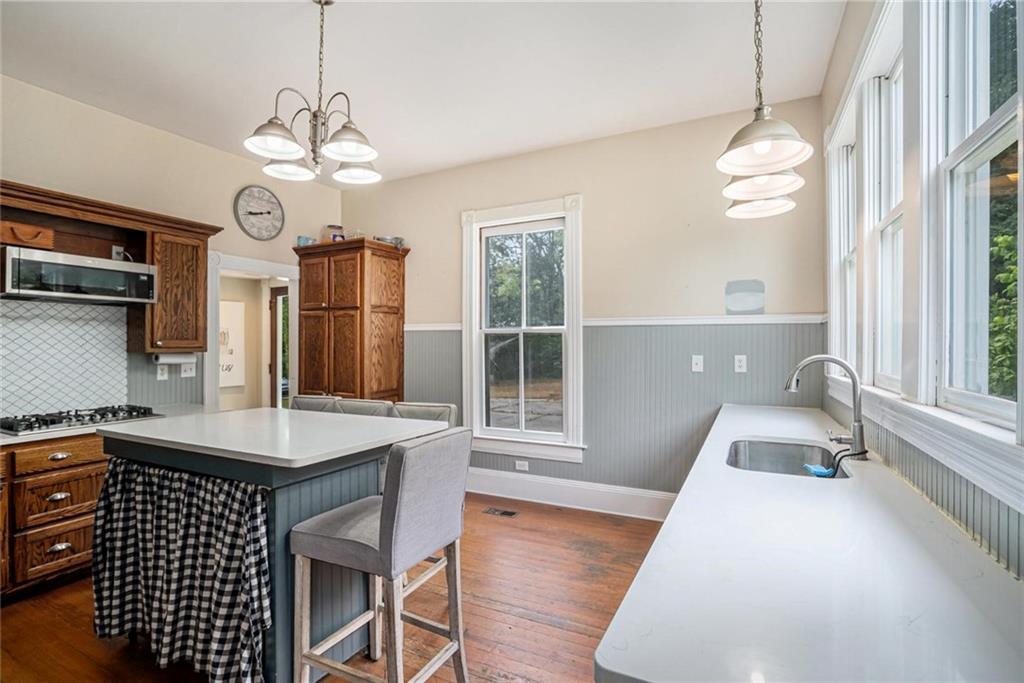 35 Old Mill Road Cedartown, GA 30125 - Photo 14 of 30 a dining room with wooden floor a chandelier a wooden table and chairs
