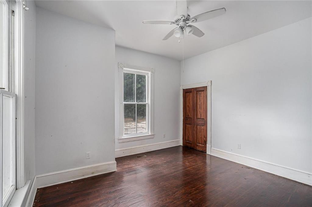 35 Old Mill Road Cedartown, GA 30125 - Photo 18 of 30 an empty room with wooden floor chandelier fan and windows