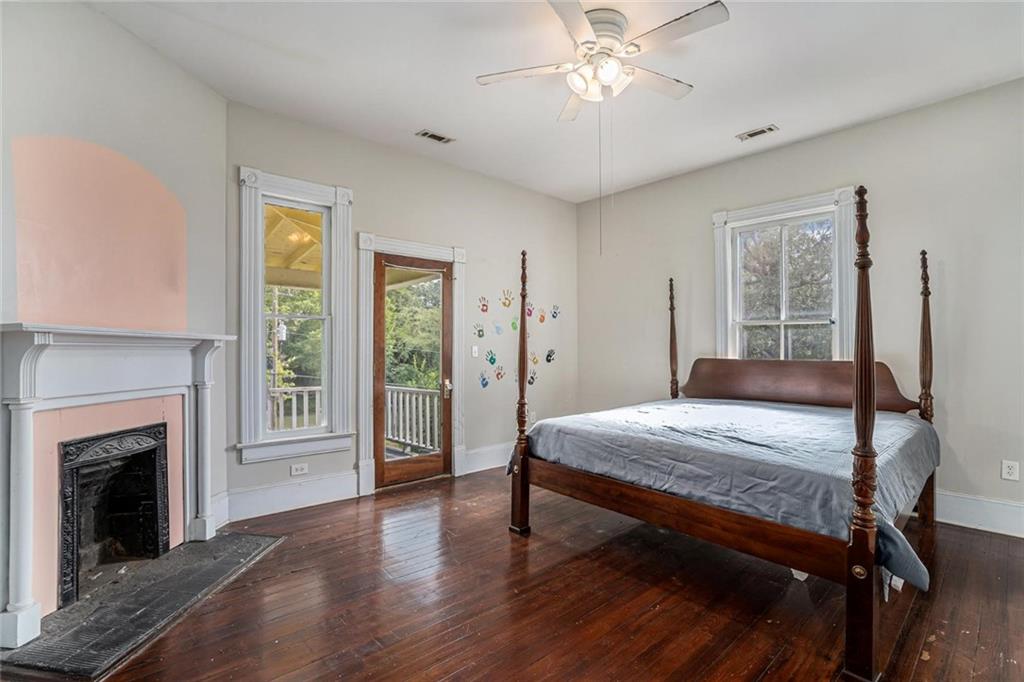 35 Old Mill Road Cedartown, GA 30125 - Photo 23 of 30 a bedroom with a large bed and a chandelier