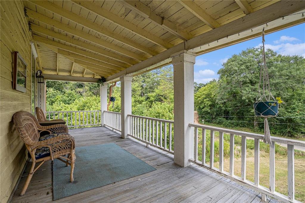 35 Old Mill Road Cedartown, GA 30125 - Photo 5 of 30 a view of a patio with table and chairs and wooden floor