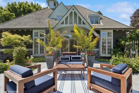 a living room with furniture a rug and a fireplace