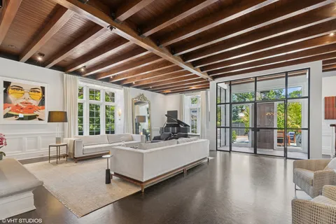a outdoor dining space with furniture and wooden floor