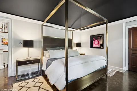 a bedroom with furniture and a large window