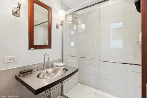 a bathroom with a shower and a sink