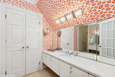 a bathroom with a sink a large mirror and a shower