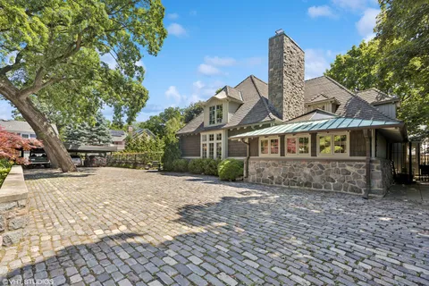 an aerial view of a house with swimming pool patio and outdoor seating