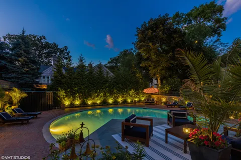 a view of a house with swimming pool and sitting area