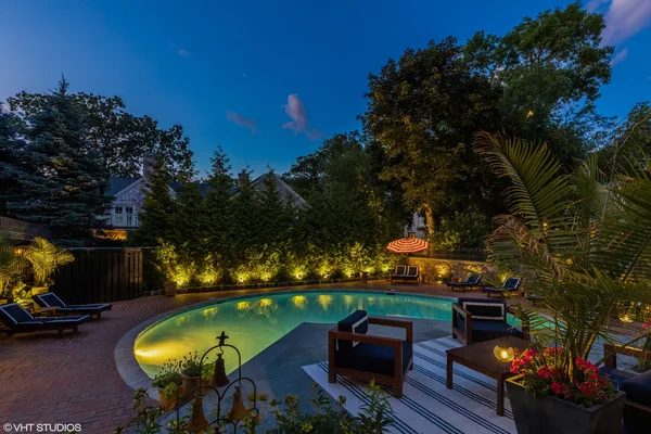 a view of a house with swimming pool and sitting area