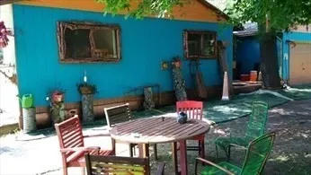 a view of a white house with a big yard and large trees