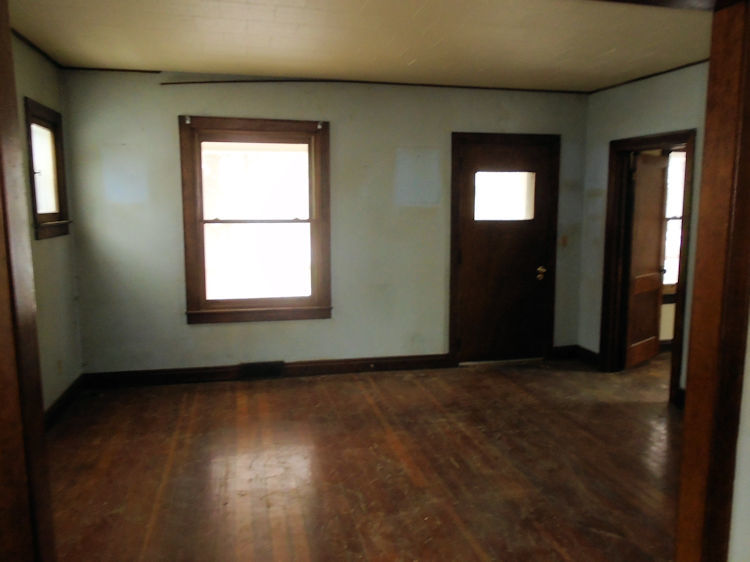 205 North 12th Street Rochelle, IL 61068 - Photo 5 of 13 an empty room with wooden floor and windows