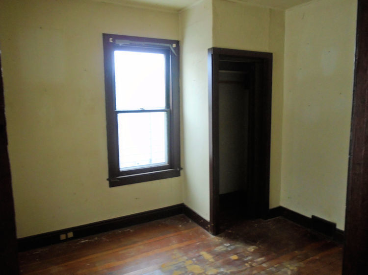 205 North 12th Street Rochelle, IL 61068 - Photo 6 of 13 an empty room with wooden floor and a window