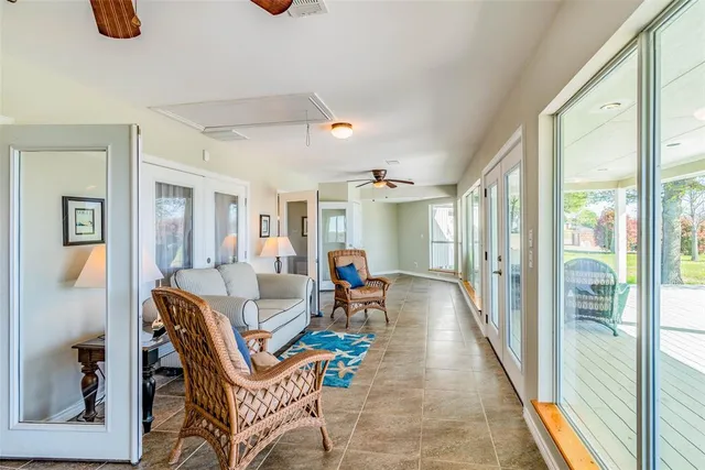 a living room with hardwood floor and large windows