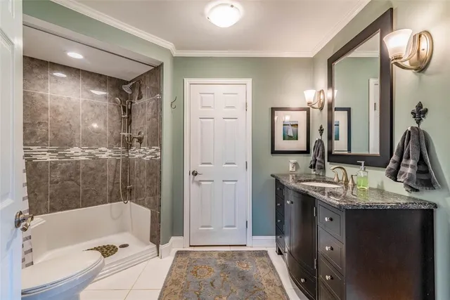 a bathroom with a double vanity sink a mirror a bathtub and shower