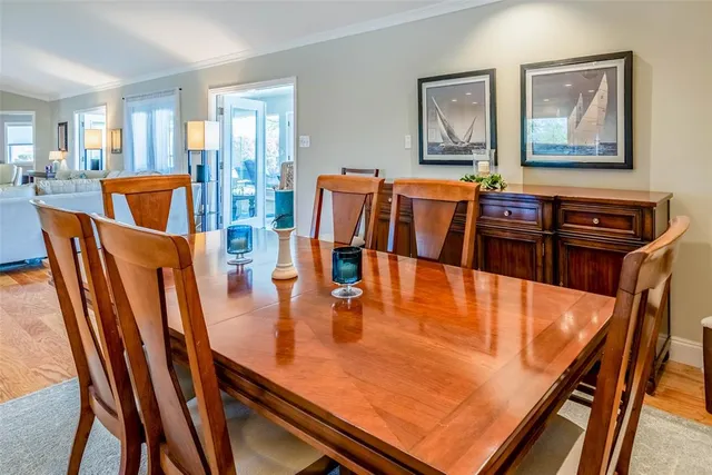 a kitchen with stainless steel appliances granite countertop a sink table and chairs
