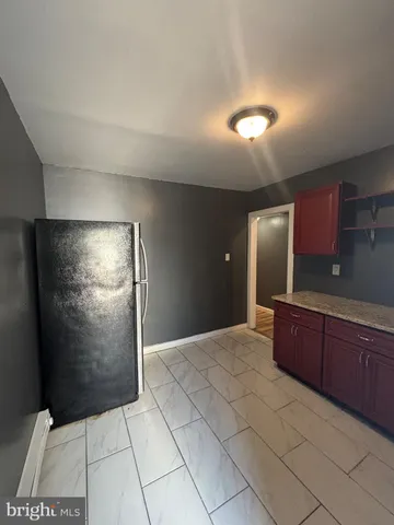a kitchen with stainless steel appliances granite countertop a refrigerator and a wooden cabinets