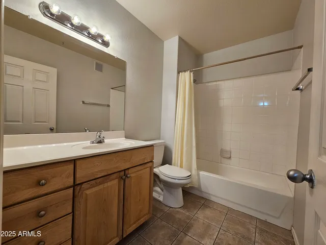 a bathroom with a double vanity sink toilet mirror and bathtub