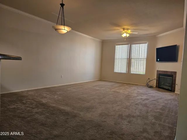 an empty room with windows and fireplace