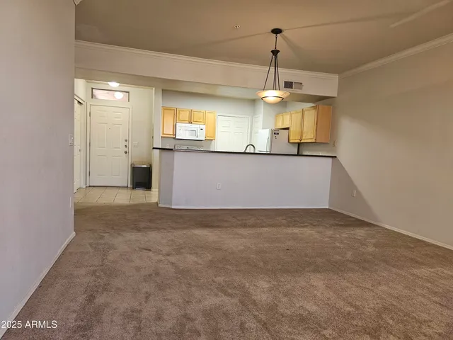 a view of a kitchen with a sink and window