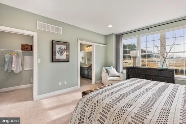 a bedroom with a large bed and a large window