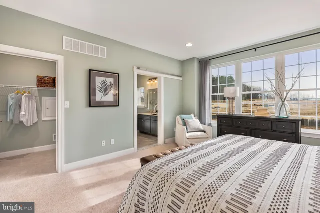 a bedroom with a large bed and a large window