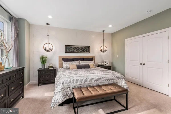 a bedroom with a bed and a dresser