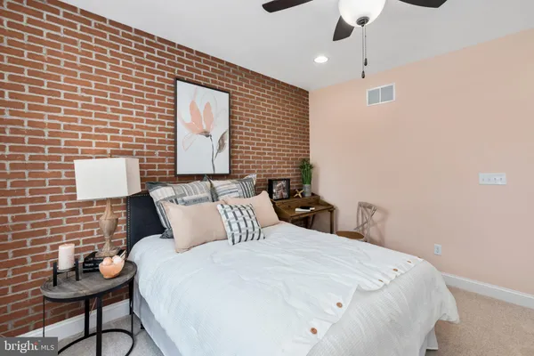 a bedroom with a bed and a lamp