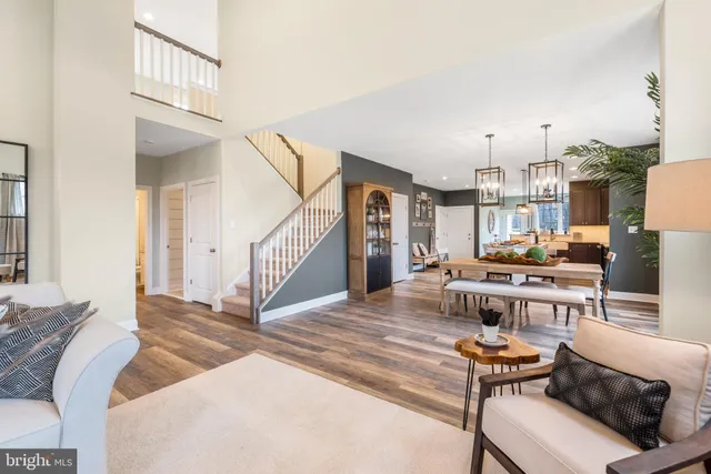 a living room with lots of furniture and a dining table