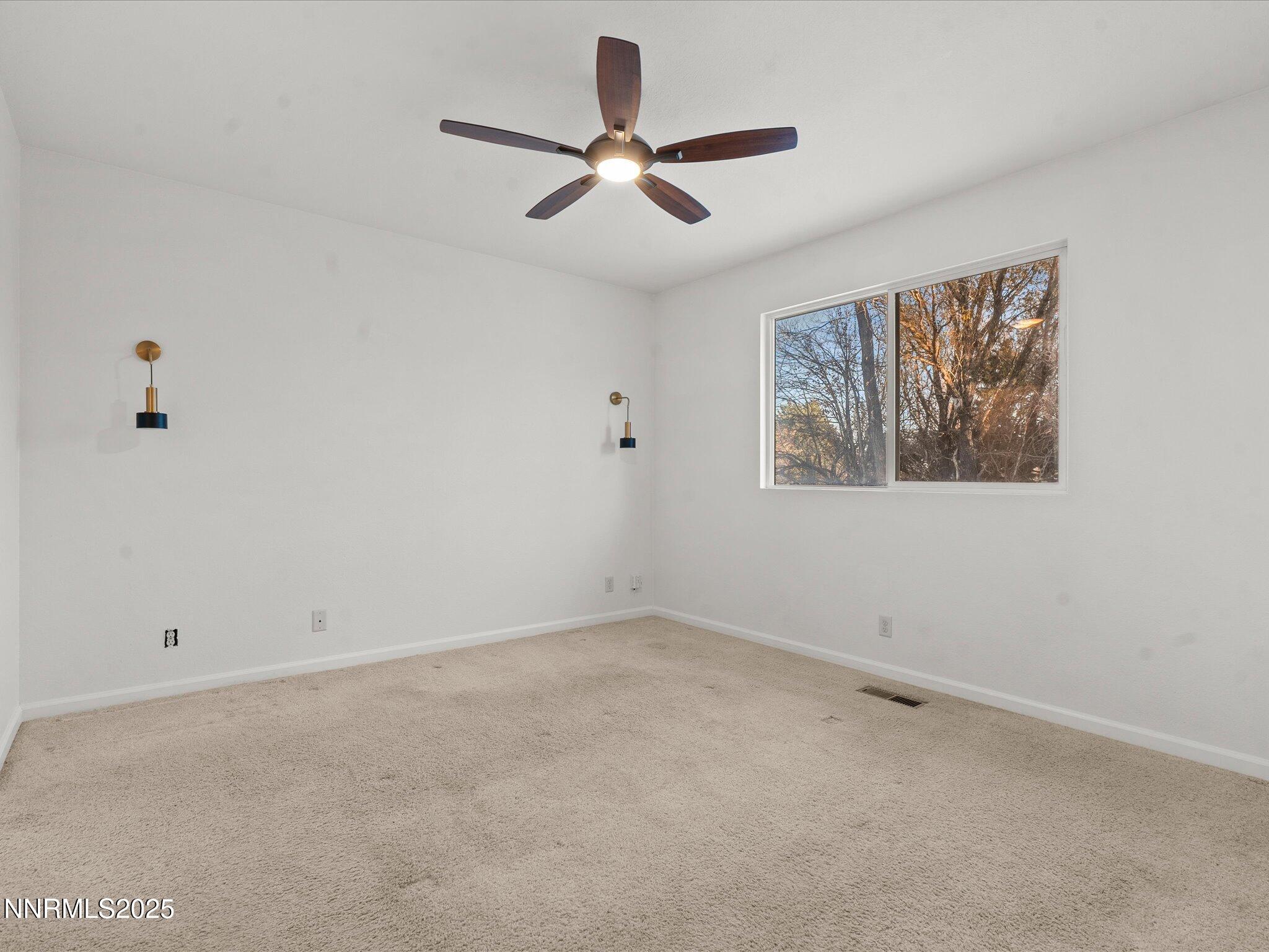 7260 Winterhill Court Reno, NV 89523 - Photo 13 of 39 wooden floor in an empty room with a window