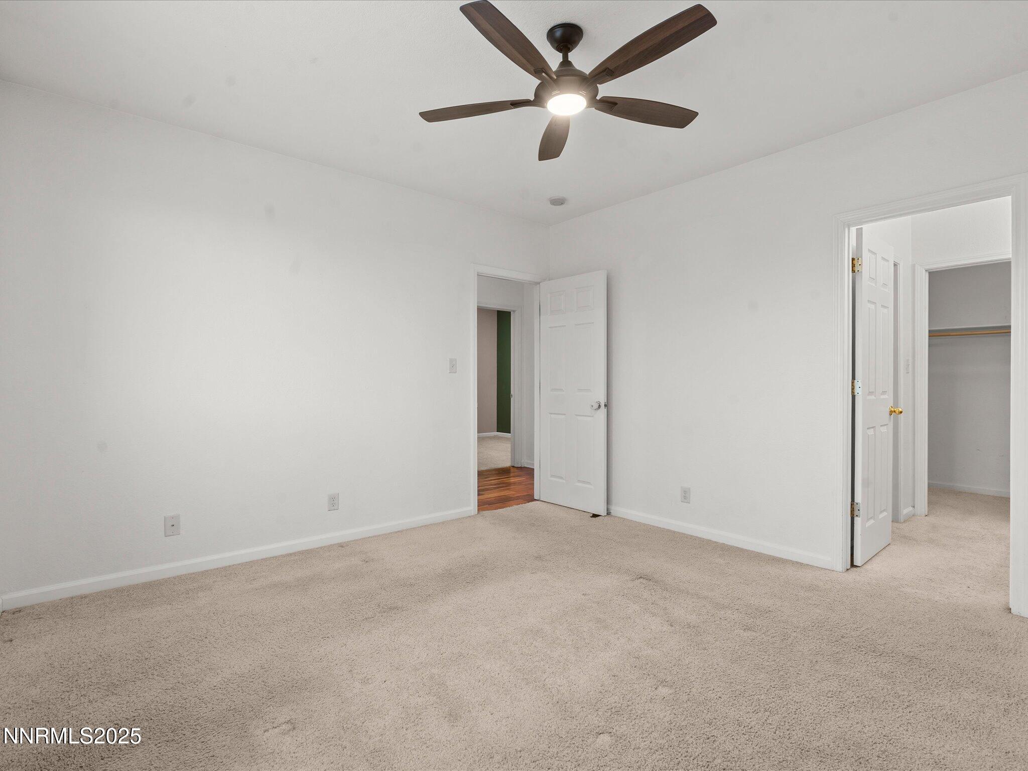 7260 Winterhill Court Reno, NV 89523 - Photo 14 of 39 an empty room with ceiling fan and window