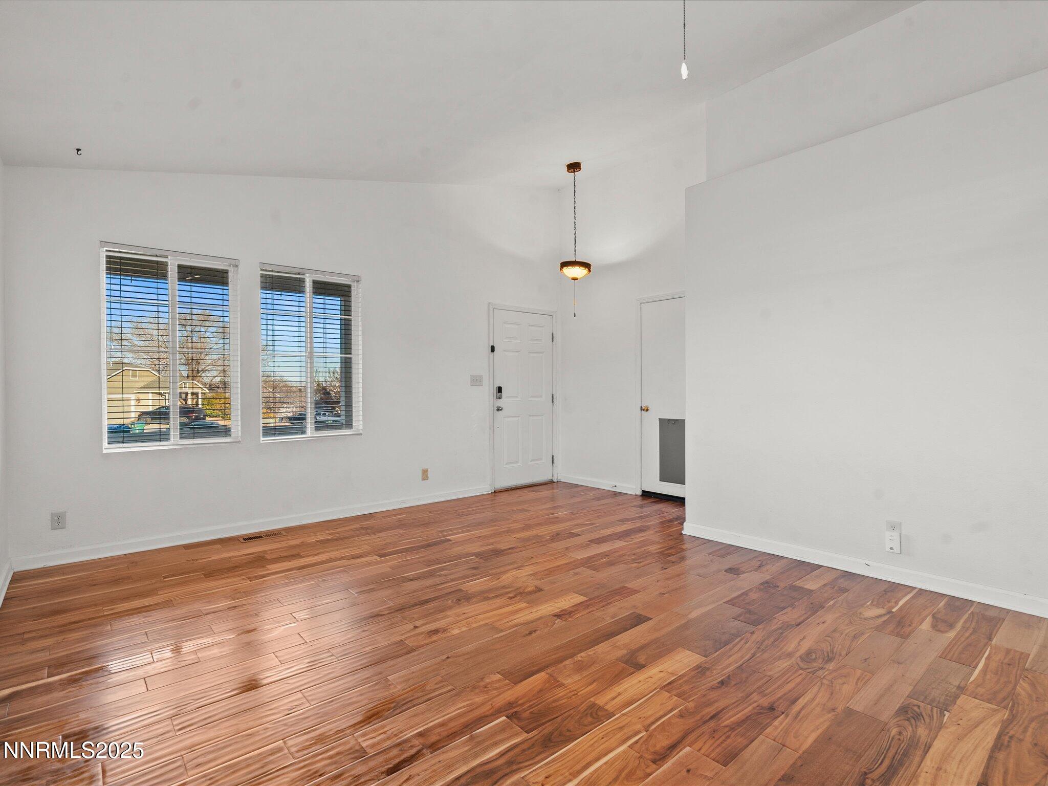 7260 Winterhill Court Reno, NV 89523 - Photo 5 of 39 an empty room with wooden floor and windows